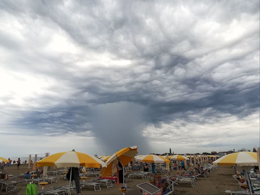 sea, storm, clouds, wind, rain, beach, umbrellas, chairs, sand HD wallpaper