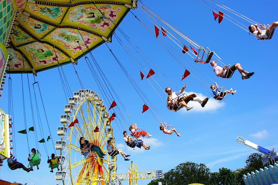 people on amusement park under blue calm sky, floral, rotating