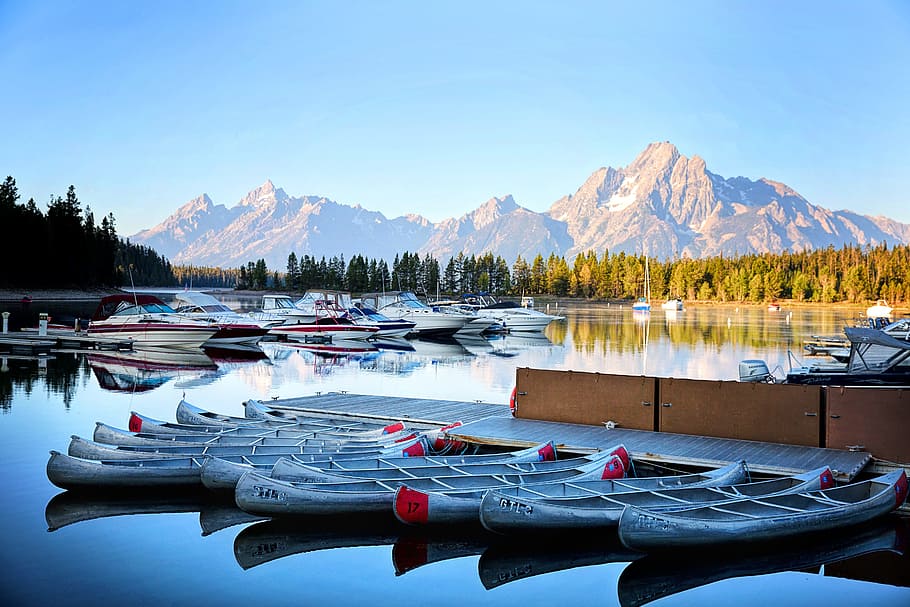white wooden boat lot, grand tetons, kayaks, boats, lake, reflections