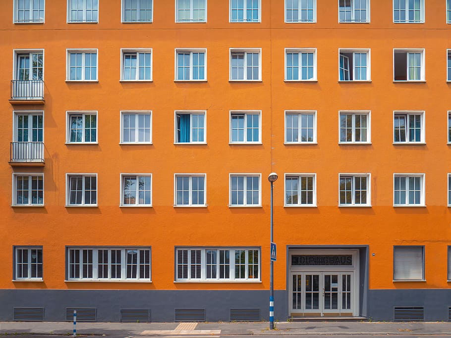 photo of orange building, gray metal pole beside orange concrete building HD wallpaper