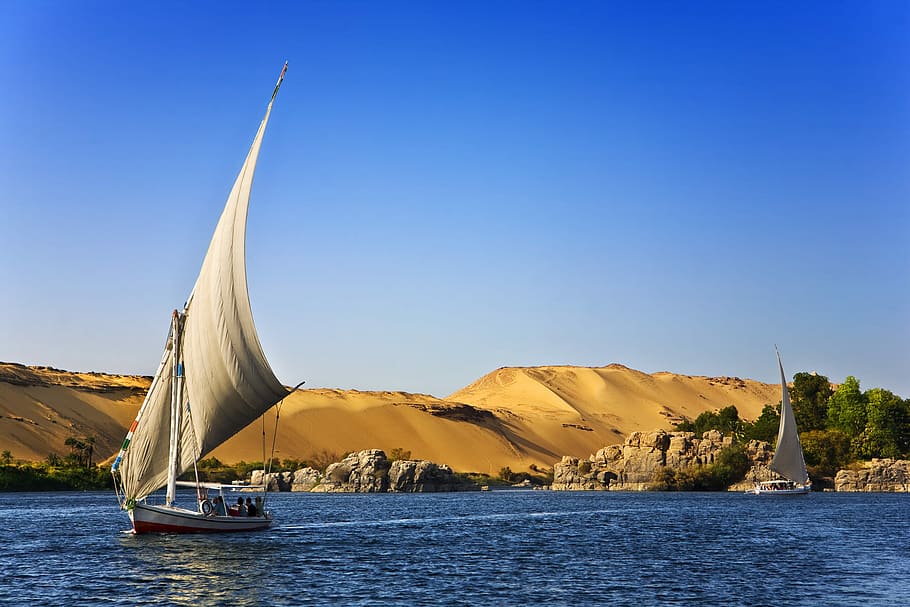 Egypt Tour Packages, two sailboats in water with desert nearby