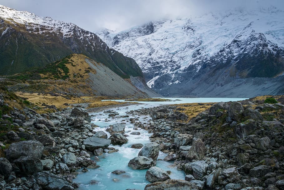 river with gray rocks near mountain covered in snow, river stream and snowy mountain HD wallpaper