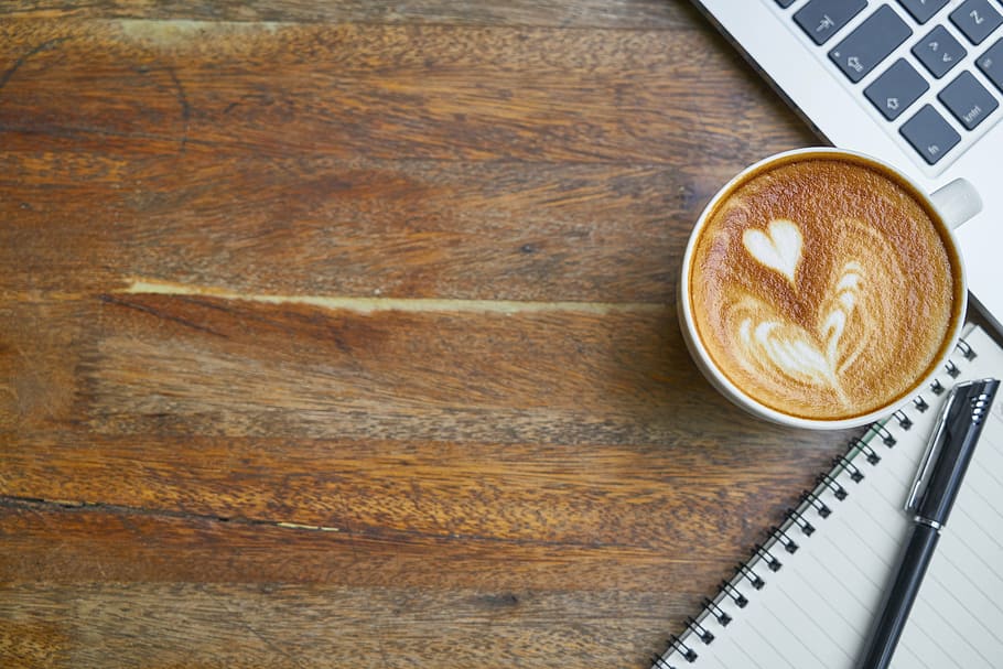 cappuccino beside lined paper with pen, coffee, cafe, table, food