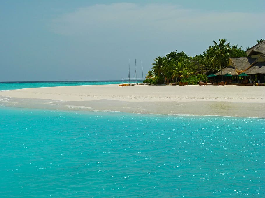 landscape photo of black house near seashore, maldives, ocean