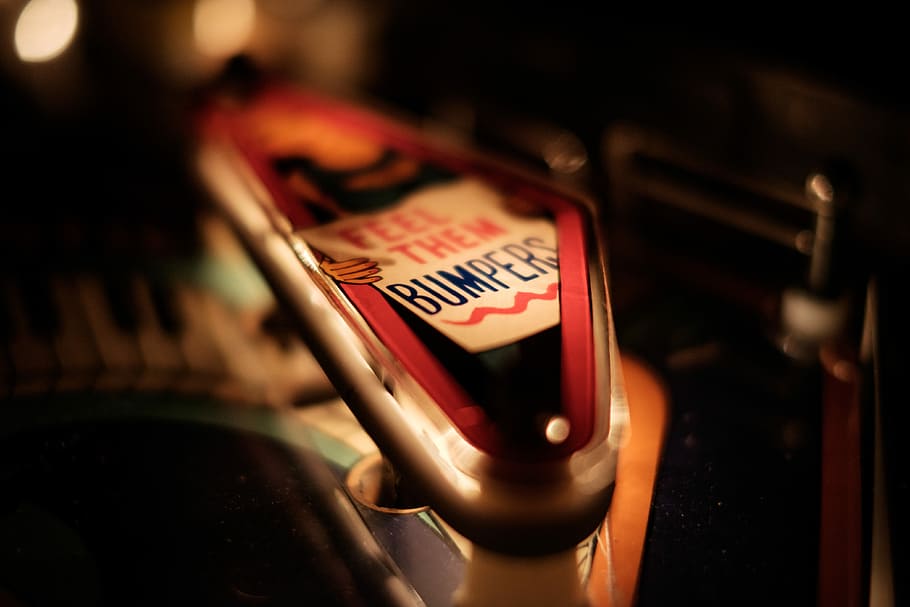 close photography of red Feel them bumpers text-printed furniture, selective focus photo of bumper printed case HD wallpaper