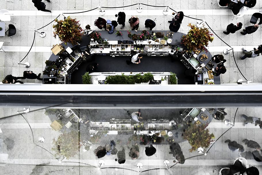 bird's eye view photograph of park, asymmetrical photo of group of people inside commercial building HD wallpaper