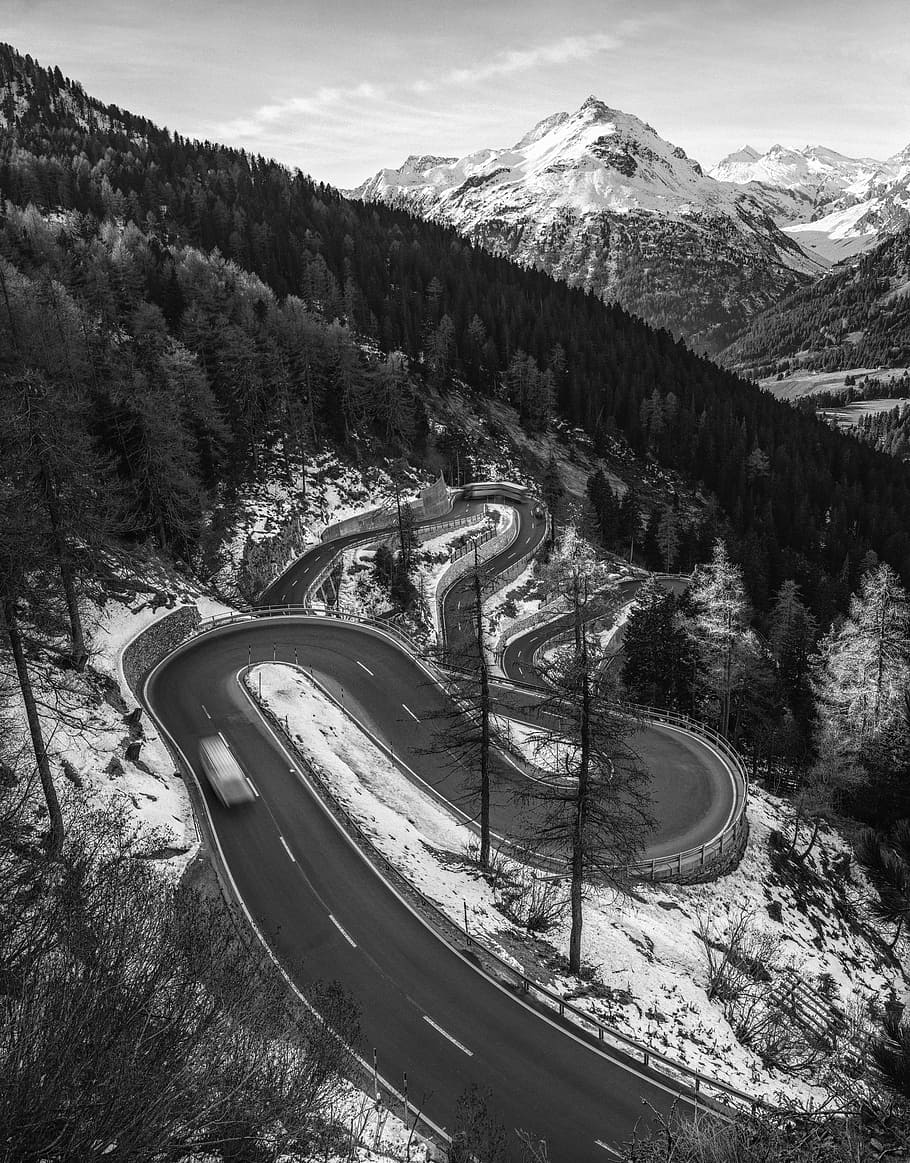 aerial view of roadway, road near trees during winter, mountain