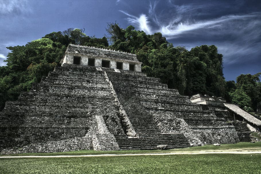 gray concrete structure surrounded by green trees, pyramid, palenque