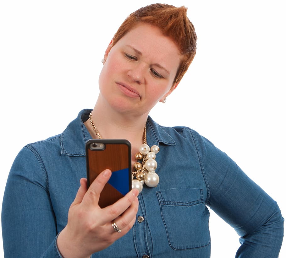 woman wearing blue chambray shirt holding smartphone, poses HD wallpaper