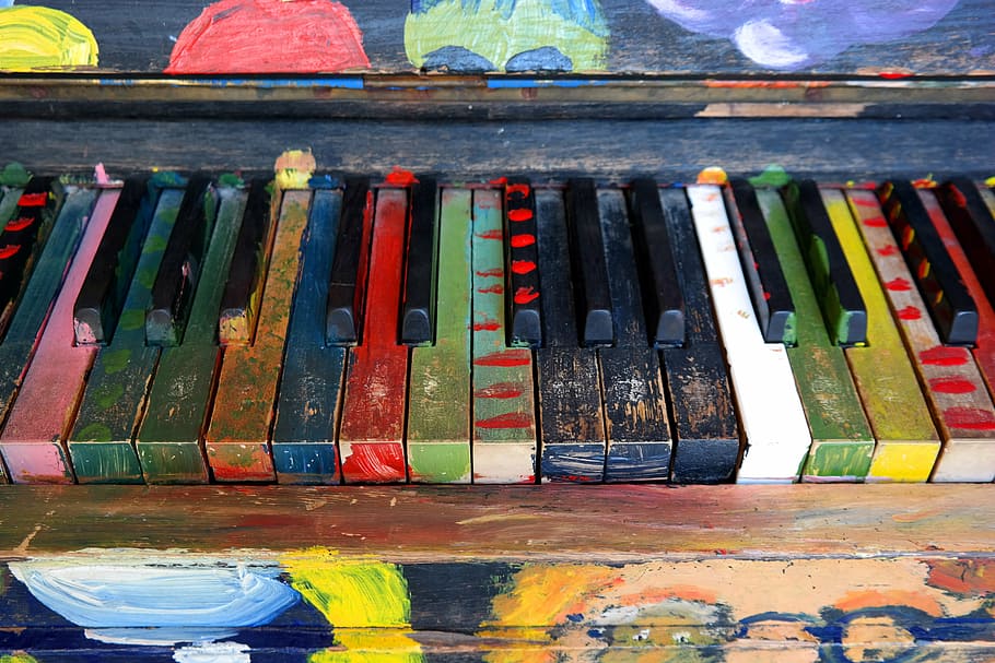 photo of painted black and multicolored piano, musical instrument