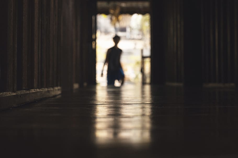 person walking inside room during daytime selective focus photography HD wallpaper