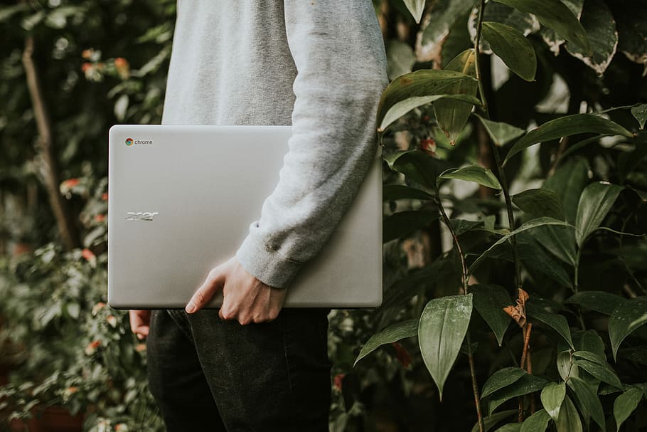 Sponsored by Google Chromebooks, person holding silver laptop computer HD wallpaper