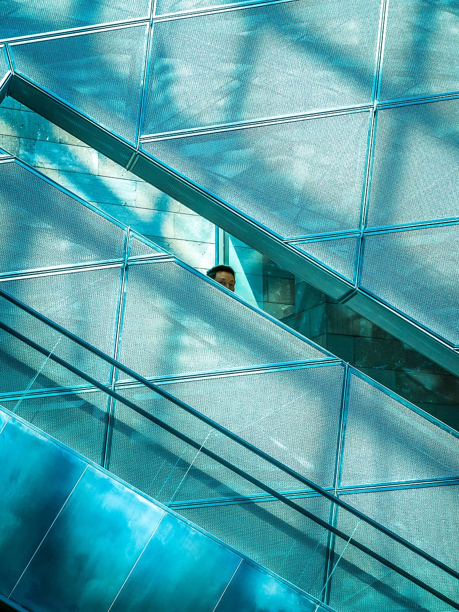 person near glass window, person peeking behind gray concrete wall HD wallpaper