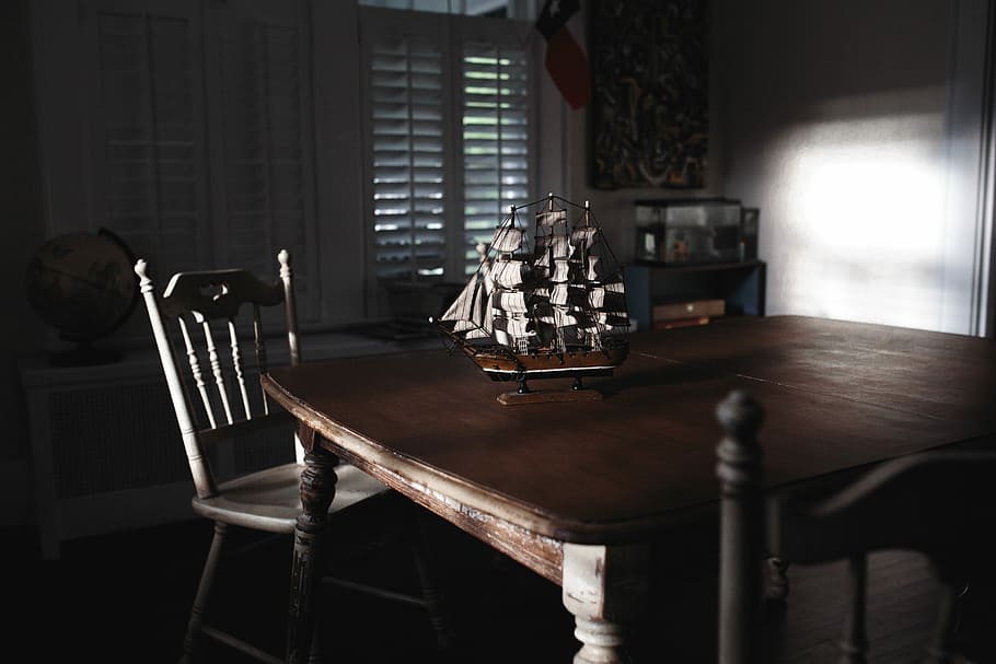 ship miniature on table, sunlight reflecting on galleon scale model on top of table near chair HD wallpaper