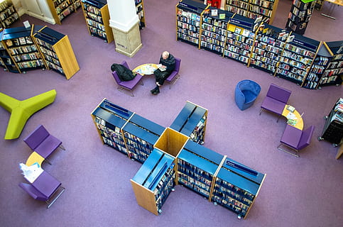 man sitting inside a library, shelf, interior, bookshelf, reference HD wallpaper