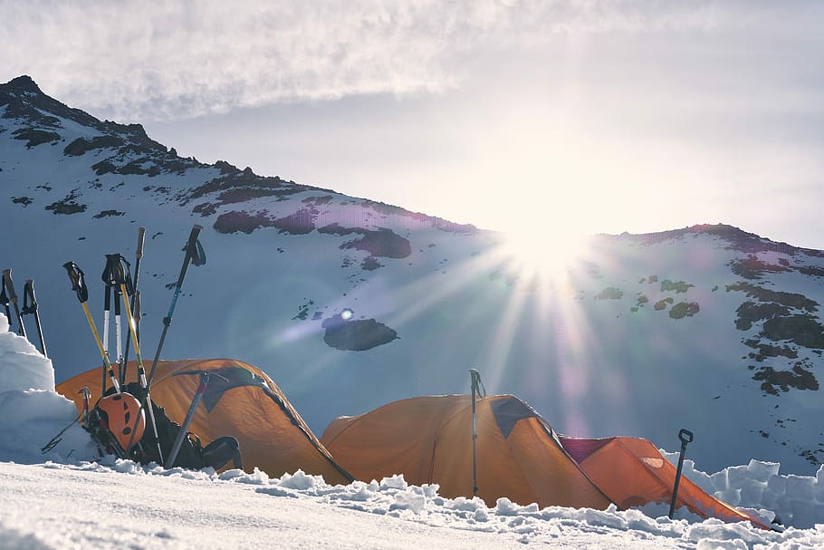 three yellow and red dome tents on snow capped mountain, dome tent on snow field near mountain alps under golden hour HD wallpaper