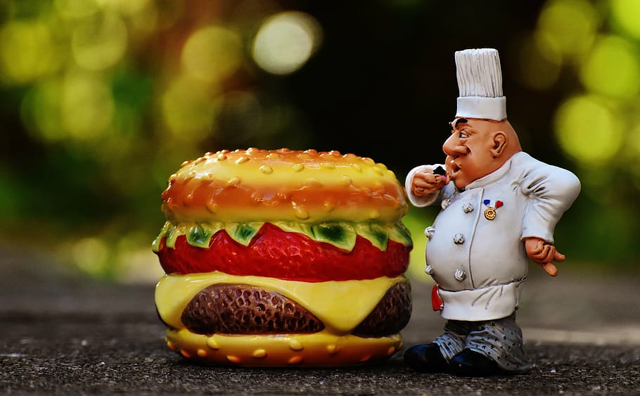 tilt-shift lens photo of a ceramic chef and burger decors, chefs