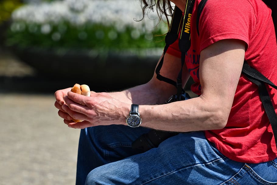 selective focus of man sitting holding hamburger, arm, hand HD wallpaper