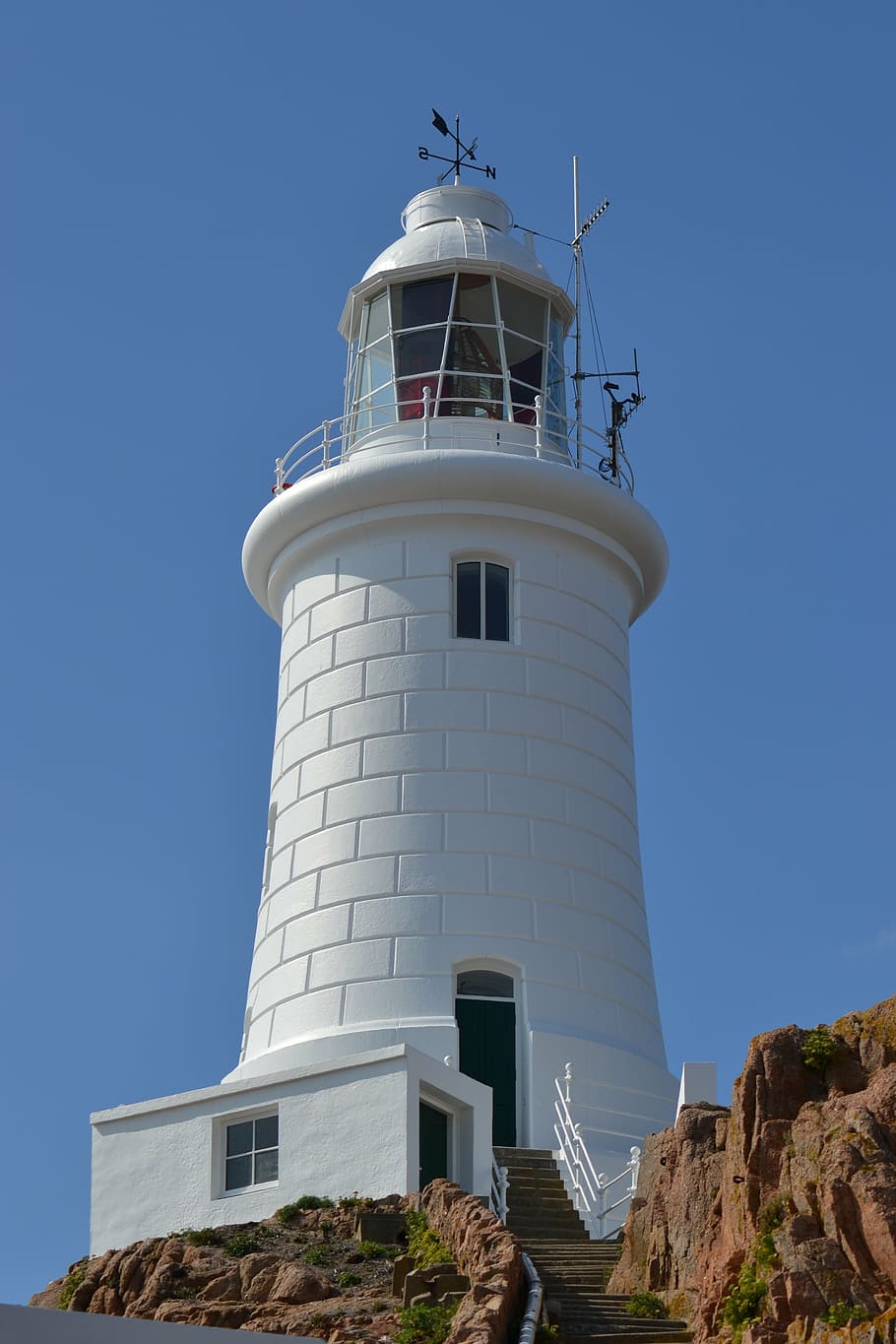 lighthouse, white, blue sky, rock, close-up, concrete block tower HD wallpaper