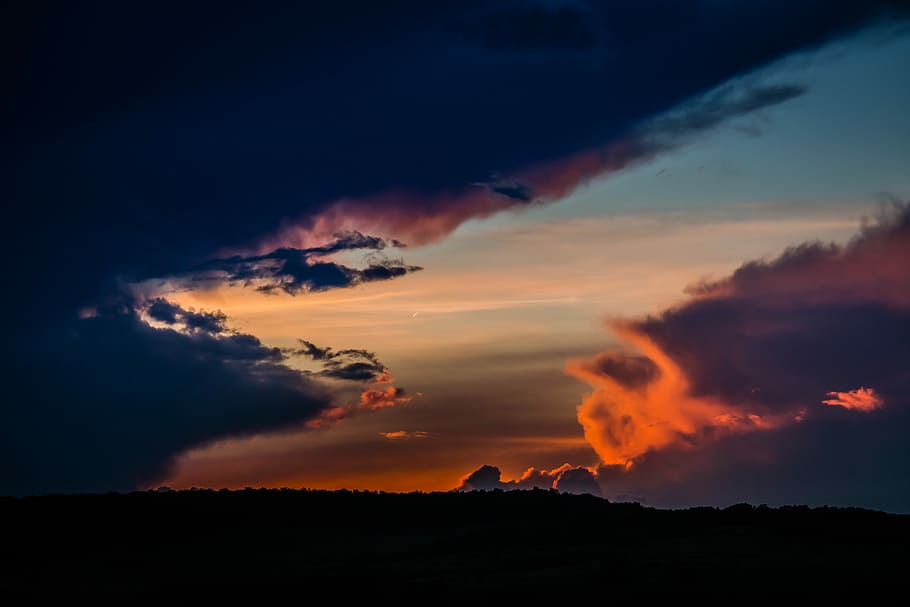 silhouette of mountain during golden hour, thick gray clouds HD wallpaper