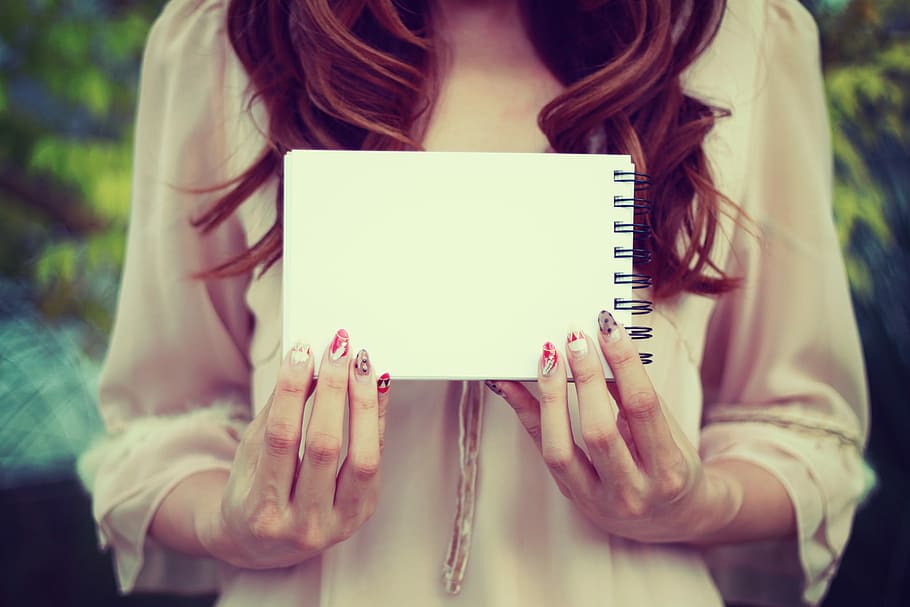 woman holding white notebook, women, outdoors, people, one Person HD wallpaper