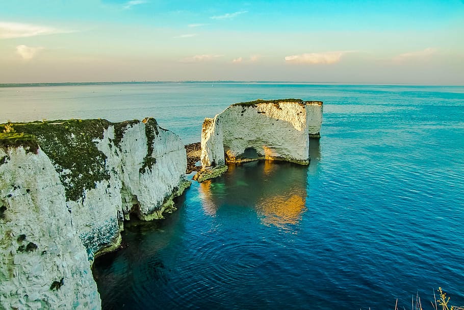 white and green rocky mountain surrounding with water, old harry rocks