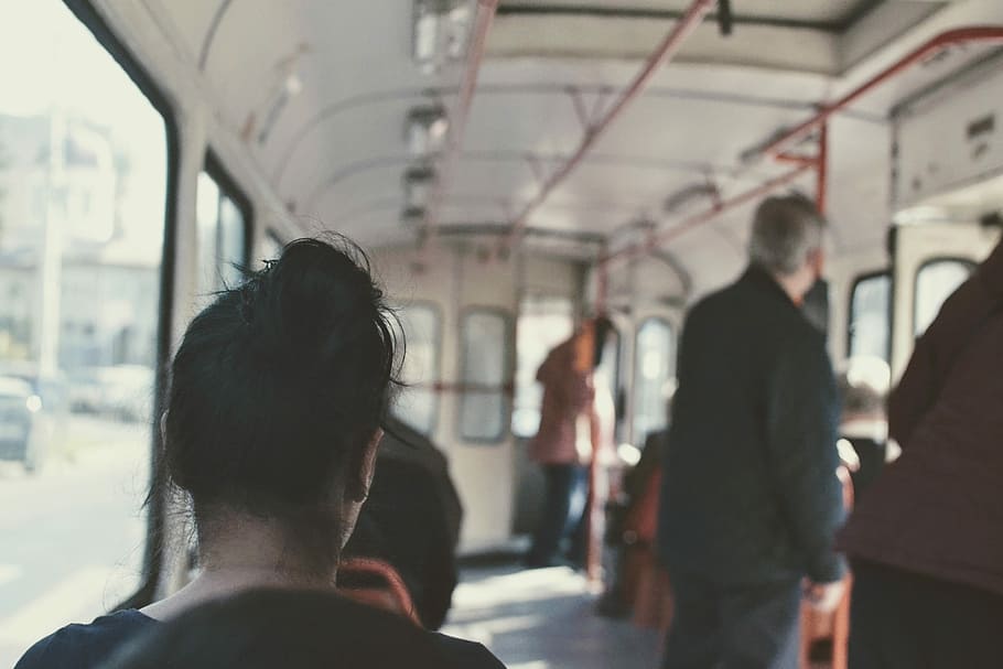 The daily commute, people inside bus at daytime, traffic, tram