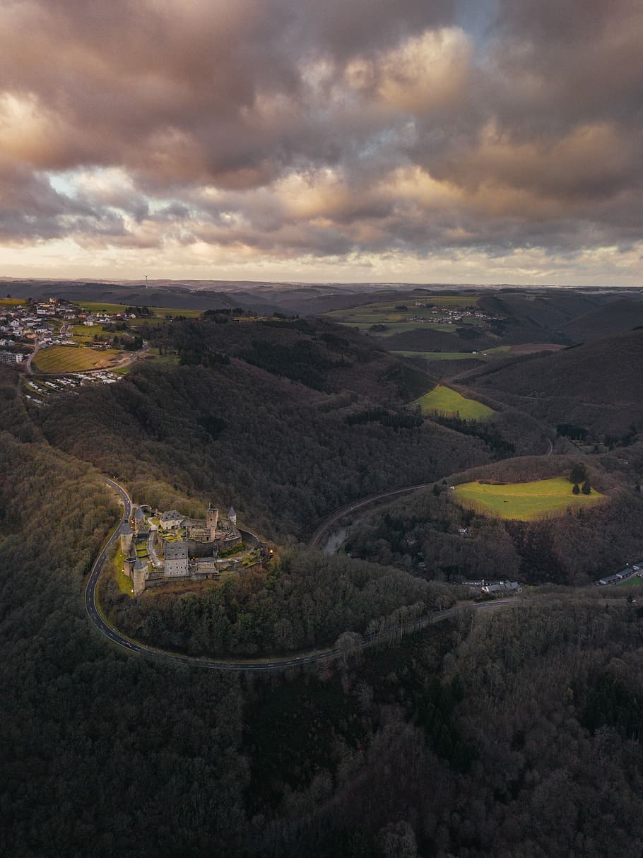 aerial view photography of castle surrounded by trees, bird's eye view of village on mountains HD wallpaper