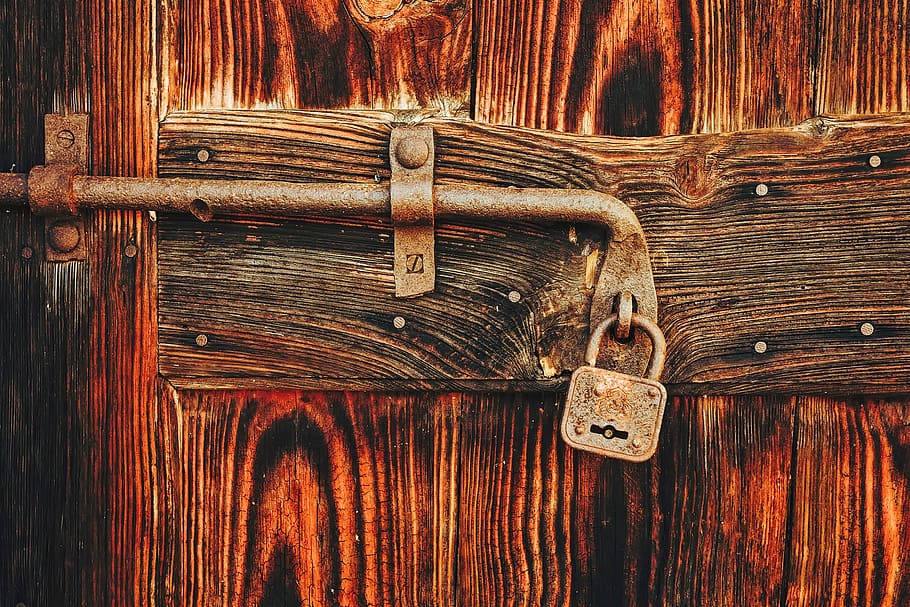 shallow focus photography of brown wooden door, lock, padlock