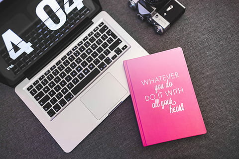 Pink notebook with a silver laptop and a camera, diary, computer HD wallpaper