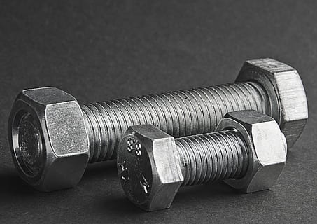 two gray steel bolts and nuts on black surface, the screws HD wallpaper