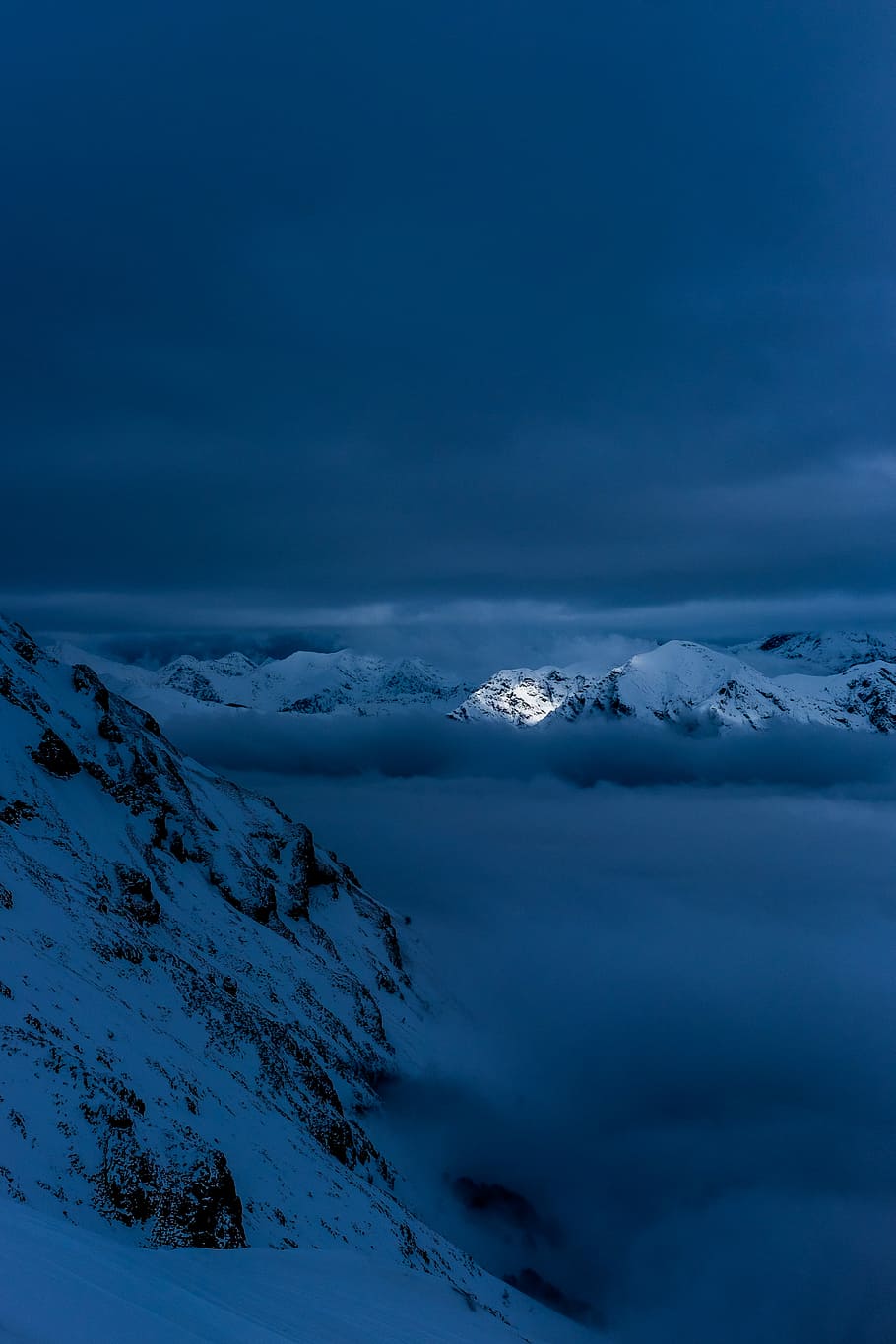 snow capped mountain covered in clouds, white mountain during night HD wallpaper