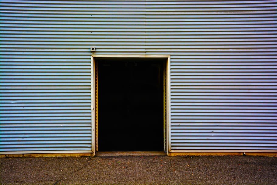 close-up photography of gray building during daytrime, open door in blue corrugated steel wall during daytime HD wallpaper