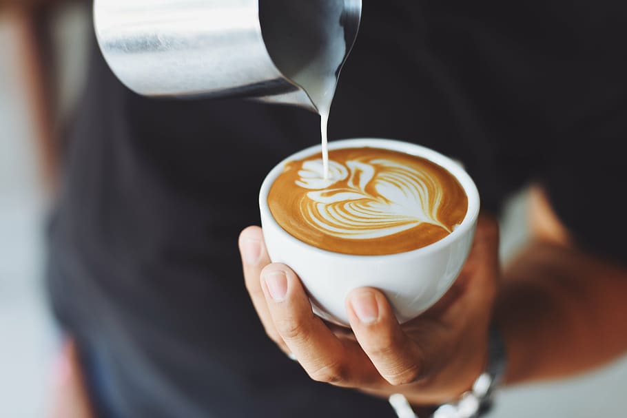 person pouring cream on latte, coffee, cafe, hot, mug, cup, white