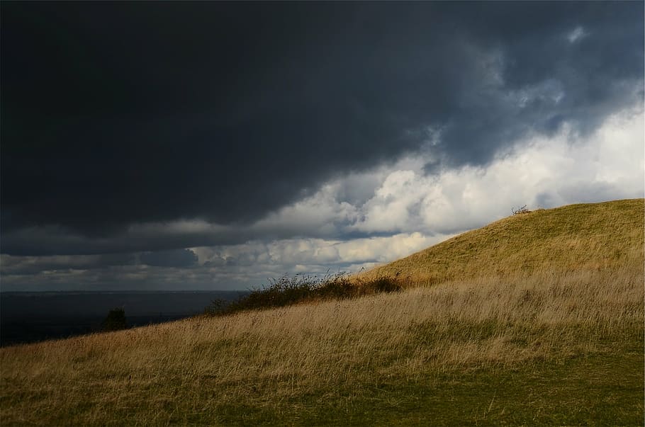 grass field under gray clouds, dark, sky, hills, daytime, storm HD wallpaper