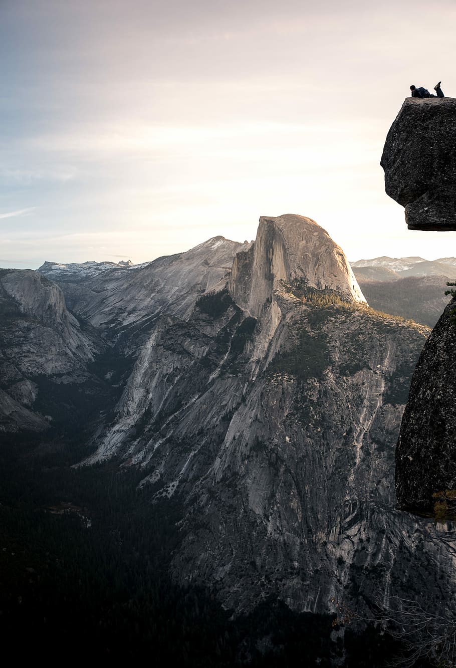 man on top stone photography, man ling above cliff during daytime HD wallpaper