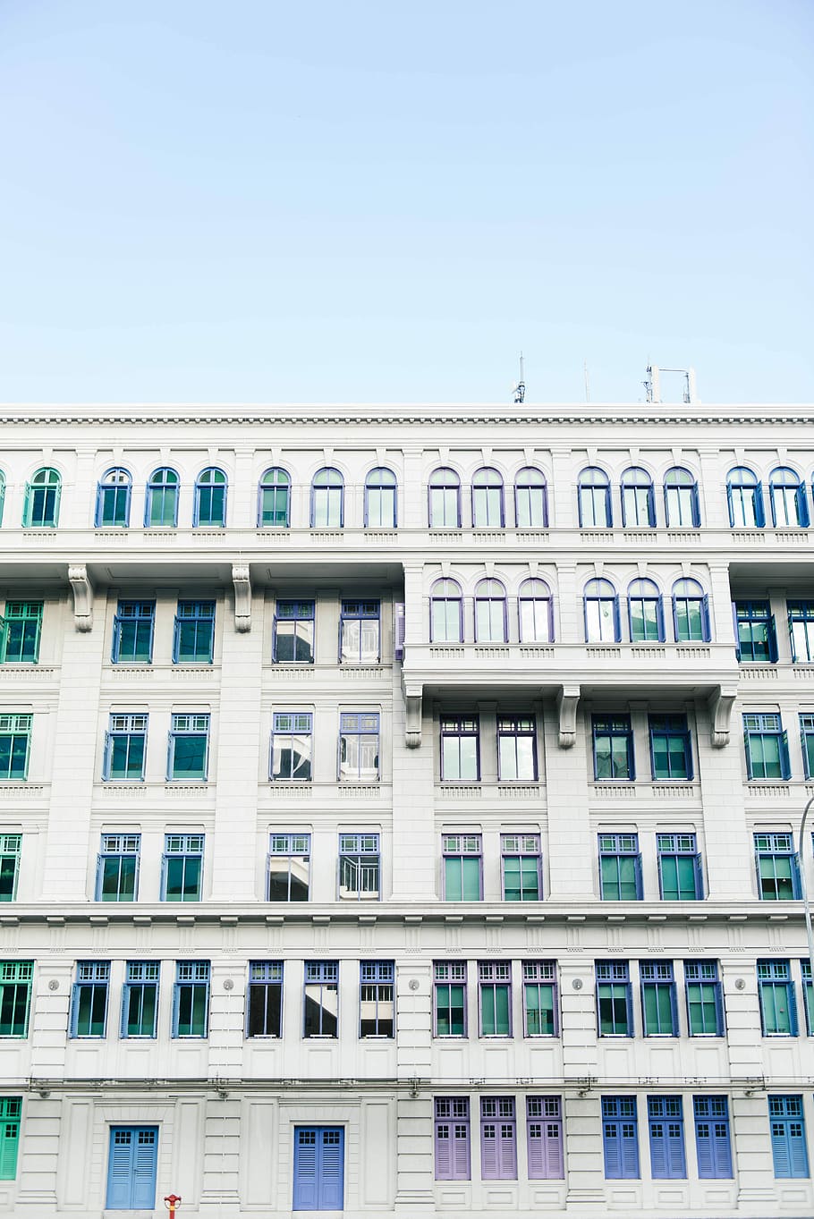 photo of white concrete building, low-angle photography of white concrete high-rise building under blue sky HD wallpaper