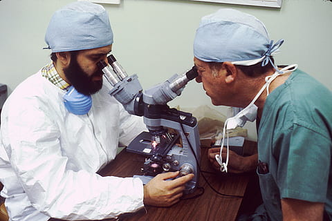 two men looking in microscope, scientist, pathologist, double overhead microscope HD wallpaper