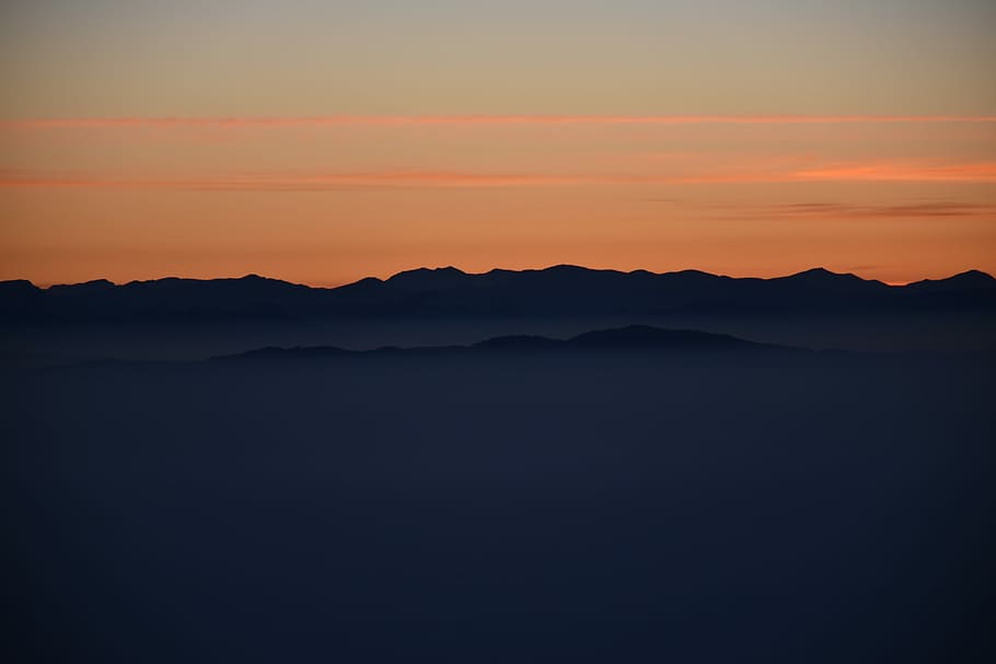 silhouette of mountains during golden hours, silhouette of mountain with fog HD wallpaper