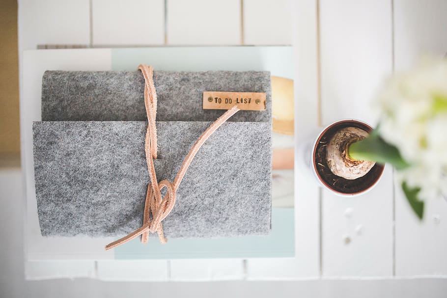 gray handbag on top of white surface, journal, notebook, felt HD wallpaper
