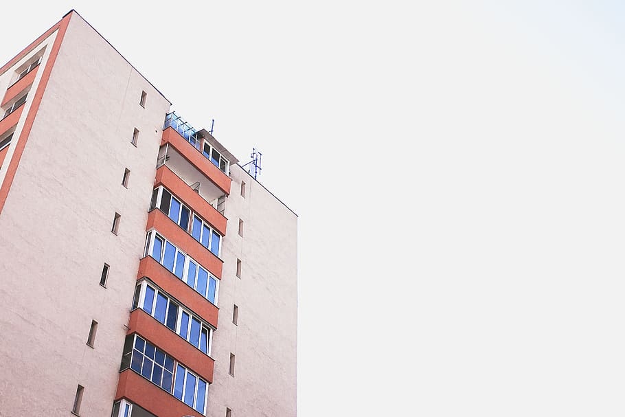 orange and blue high-rise building during clear sky, low-angle photography of gray and red building HD wallpaper