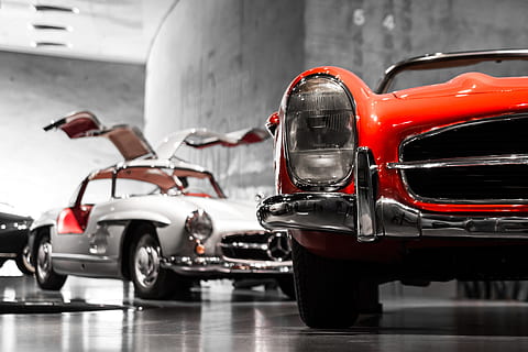 two vintage cars beside gray concrete wall, photography of white and red cars HD wallpaper