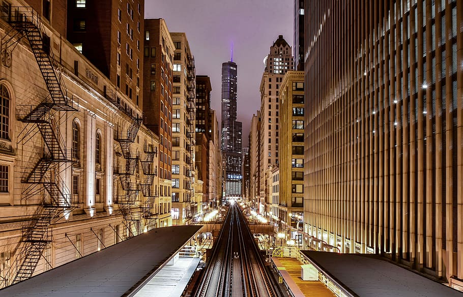 pathways in between building, black steel train track beside high rise building HD wallpaper