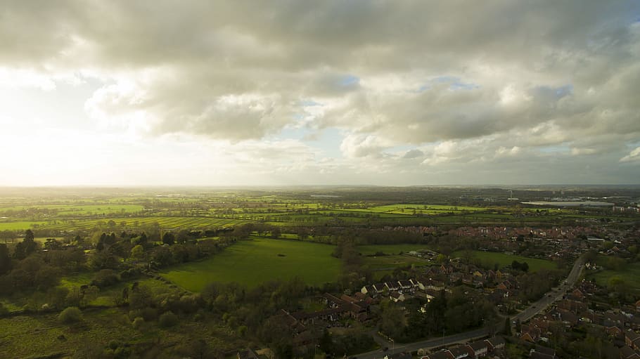 aerial view of city under cloudy sky, sun, light, field, cloud - sky HD wallpaper