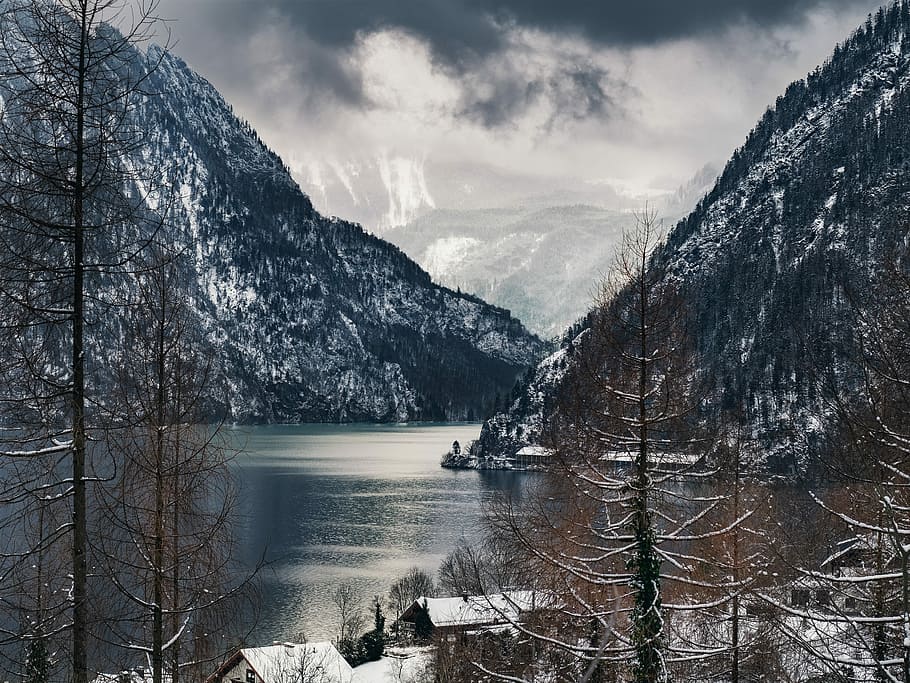body of water surrounded with mountains, photo of body of water between rock formations HD wallpaper