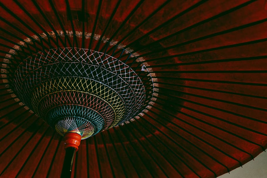 closeup photography of round multicolored ceiling, low light photography of red kyoto umbrella