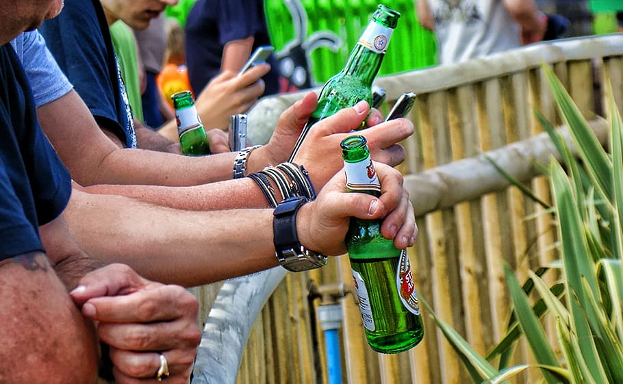 four men leaning on brown bamboo balustrade holding green bottles HD wallpaper
