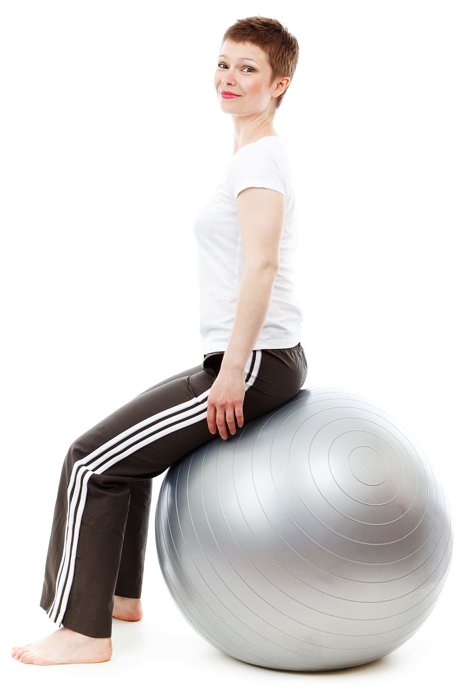 woman in white shirt and black sweat pants sitting on gray stability ball HD wallpaper
