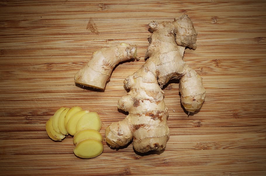 ginger and sliced gingers on wooden tabletop, the root of the
