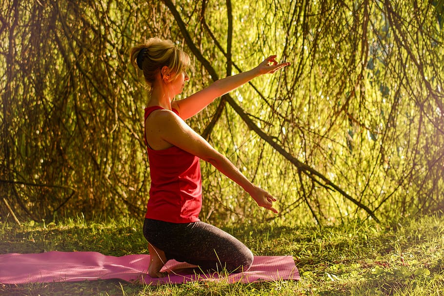 woman doing yoga beside plants, calm, release, stretching, golden hour HD wallpaper